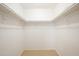 Walk-in closet with basic shelving, neutral walls, and tile floors provide ample storage space at 8055 W Sanna St, Peoria, AZ 85345