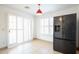 Eat in Kitchen space featuring tile floors, white walls, large refrigerator, and shuttered doors to patio at 8055 W Sanna St, Peoria, AZ 85345