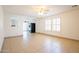 Bright living room with tile, white walls, lots of windows, and an archway through to the kitchen at 8055 W Sanna St, Peoria, AZ 85345