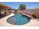Backyard pool featuring a waterfall feature, rock accents, and covered patio area for outdoor living at 8055 W Sanna St, Peoria, AZ 85345