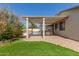 Spacious backyard with covered patio, outdoor kitchen, in-ground pool, and lush landscaping at 8256 W Bloomfield Rd, Peoria, AZ 85381