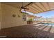 Backyard patio features outdoor kitchen, pool, and spa at 8256 W Bloomfield Rd, Peoria, AZ 85381