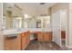Bathroom with dual sinks, wood cabinets, large mirrors, and updated vanity at 8256 W Bloomfield Rd, Peoria, AZ 85381