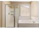 Bathroom featuring a glass enclosed shower, soaking tub, and tiled walls at 8256 W Bloomfield Rd, Peoria, AZ 85381