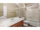 Bathroom features a tub with glass shower door, toilet, and vanity with sink at 8256 W Bloomfield Rd, Peoria, AZ 85381