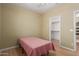 Bedroom showcases a single bed, closet, wood floors, and neutral colored walls at 8256 W Bloomfield Rd, Peoria, AZ 85381