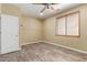 Bedroom features wood-look floors, neutral paint, and a window with blinds at 8256 W Bloomfield Rd, Peoria, AZ 85381