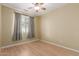 Bedroom featuring wood laminate flooring, and window at 8256 W Bloomfield Rd, Peoria, AZ 85381