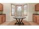 Cozy breakfast nook featuring a round table and bay windows with plantation shutters at 8256 W Bloomfield Rd, Peoria, AZ 85381