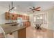 Bright kitchen featuring wood cabinets, modern appliances, peninsula, and a breakfast nook with bay window at 8256 W Bloomfield Rd, Peoria, AZ 85381