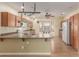 Bright open kitchen featuring wood cabinets, modern appliances, peninsula, and a breakfast nook at 8256 W Bloomfield Rd, Peoria, AZ 85381