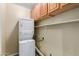 Laundry area with stacked washer and dryer with cabinets and shelf at 8256 W Bloomfield Rd, Peoria, AZ 85381
