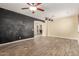 Open-concept living room featuring modern light fixtures and stylish wood-look tile flooring at 8256 W Bloomfield Rd, Peoria, AZ 85381