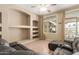 Open living room with custom shelves, large windows, and access to the outdoor area at 8256 W Bloomfield Rd, Peoria, AZ 85381