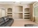Bright living room featuring custom built-in shelving and lots of natural light at 8256 W Bloomfield Rd, Peoria, AZ 85381