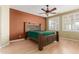 Spacious bedroom featuring wood laminate flooring, ceiling fan, and windows with shutters at 8256 W Bloomfield Rd, Peoria, AZ 85381