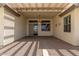 Covered patio with brick pavers, ceiling fan, and stucco walls at 8256 W Bloomfield Rd, Peoria, AZ 85381