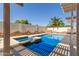 Relaxing pool area with spa, pergola, and custom painted sunflower privacy wall. The perfect backyard oasis! at 8256 W Bloomfield Rd, Peoria, AZ 85381