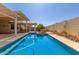 Beautiful in-ground pool with pergola and custom painted sunflower-themed privacy wall. Perfect for outdoor fun! at 8256 W Bloomfield Rd, Peoria, AZ 85381