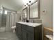 Bathroom with a double sink vanity, marble countertops, and modern fixtures at 8750 E Starlight Way, Scottsdale, AZ 85250