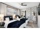 Comfortable bedroom with a ceiling fan, natural light, and minimalist decor at 8750 E Starlight Way, Scottsdale, AZ 85250