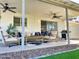Comfortable covered patio with a ceiling fan and well-decorated outdoor seating area at 8750 E Starlight Way, Scottsdale, AZ 85250
