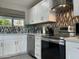 Bright kitchen features white cabinets, stainless steel appliances, subway tile backsplash, and granite countertops at 8750 E Starlight Way, Scottsdale, AZ 85250