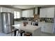 Modern kitchen featuring white cabinets, stainless steel appliances, quartz countertops and decorative backsplash at 8750 E Starlight Way, Scottsdale, AZ 85250