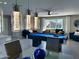 This living room boasts a pool table and comfortable seating, flooded with natural light at 8750 E Starlight Way, Scottsdale, AZ 85250