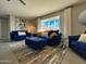 Stylish living room with blue velvet furniture and ample natural light at 8750 E Starlight Way, Scottsdale, AZ 85250