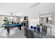 Open-concept living space with a pool table, dining area, and contemporary decor, perfect for entertaining at 8750 E Starlight Way, Scottsdale, AZ 85250