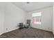 A room with a neutral color scheme, carpet flooring, and a large window that allows natural light at 8832 E Pueblo Ave # 71, Mesa, AZ 85208