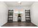 Versatile room with stylish ladder shelves, wood-look flooring, and natural light from the windows at 8832 E Pueblo Ave # 71, Mesa, AZ 85208