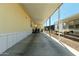 Spacious carport with ample parking and storage space leading to an access door at 8832 E Pueblo Ave # 71, Mesa, AZ 85208