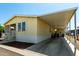 Butterscotch-colored home featuring covered parking and a clean well maintained landscape at 8832 E Pueblo Ave # 71, Mesa, AZ 85208