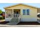 Inviting butterscotch-colored home featuring a cozy covered porch, and freshly mulched garden beds at 8832 E Pueblo Ave # 71, Mesa, AZ 85208