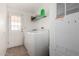 Clean laundry room features a washing machine and dryer, a storage rack, and a back door to the outside at 8832 E Pueblo Ave # 71, Mesa, AZ 85208