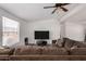 Bright living room showcasing a large flat-screen TV and cozy brown sectional couch at 8832 E Pueblo Ave # 71, Mesa, AZ 85208