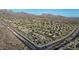 Aerial view of planned community, showcasing organized streets, desert landscape, and mountain views at 10253 E Indigo Dr, Scottsdale, AZ 85255
