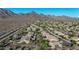 Aerial view of neighborhood in a desert community, featuring mountain views, and single Gathering homes at 10253 E Indigo Dr, Scottsdale, AZ 85255