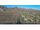 Expansive aerial view of a desert community nestled near mountains, showcasing the landscape and residential layout at 10253 E Indigo Dr, Scottsdale, AZ 85255
