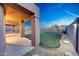 Covered patio overlooking a well-maintained backyard with artificial turf and desert landscaping at 10253 E Indigo Dr, Scottsdale, AZ 85255