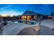 Backyard featuring a fenced pool with mature trees, desert landscaping, and a covered patio at 10253 E Indigo Dr, Scottsdale, AZ 85255