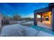 Home's backyard featuring a sparkling fenced pool area and covered patio with stone accents at 10253 E Indigo Dr, Scottsdale, AZ 85255