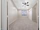 Cozy bedroom shows neutral colors, with carpet, ceiling fan, and a closet for space-saving storage at 10253 E Indigo Dr, Scottsdale, AZ 85255