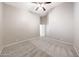 Carpeted bedroom includes a ceiling fan, neutral paint, and ample space for furniture arrangements at 10253 E Indigo Dr, Scottsdale, AZ 85255