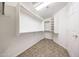 Walk-in closet featuring hanging bars, and built-in shelving for ample storage at 10253 E Indigo Dr, Scottsdale, AZ 85255