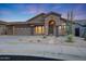 Inviting single-story home with desert landscaping, stucco facade, and a welcoming front entrance at 10253 E Indigo Dr, Scottsdale, AZ 85255