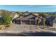 Beautiful home featuring a desert landscape, spacious 3-car garage, and a charming front entrance at 10253 E Indigo Dr, Scottsdale, AZ 85255