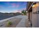 Street view of house with desert landscaping and mountain views at sunset at 10253 E Indigo Dr, Scottsdale, AZ 85255